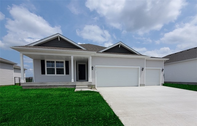 view of front of home featuring a front yard and a garage