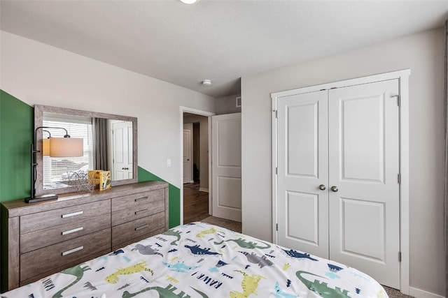 bedroom featuring dark hardwood / wood-style flooring and a closet