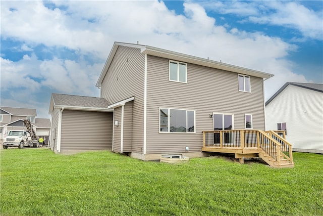 back of house featuring a lawn and a wooden deck