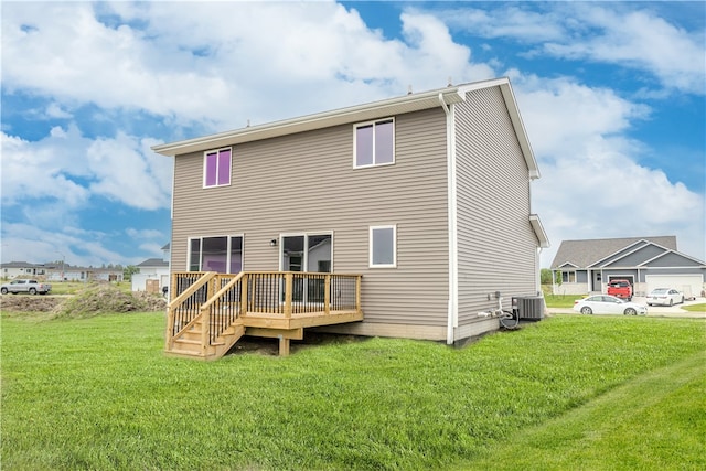 rear view of property featuring a yard, a deck, and central AC unit