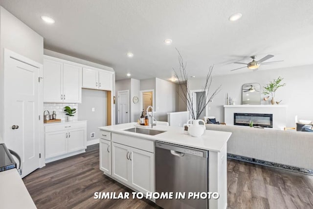 kitchen featuring dark hardwood / wood-style floors, dishwasher, sink, white cabinets, and a kitchen island with sink