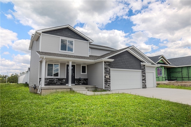 craftsman-style home featuring a porch, a front lawn, and a garage