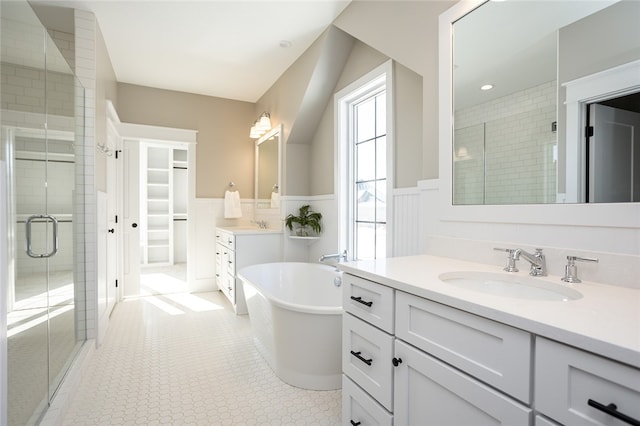 bathroom with vanity, shower with separate bathtub, and tile floors