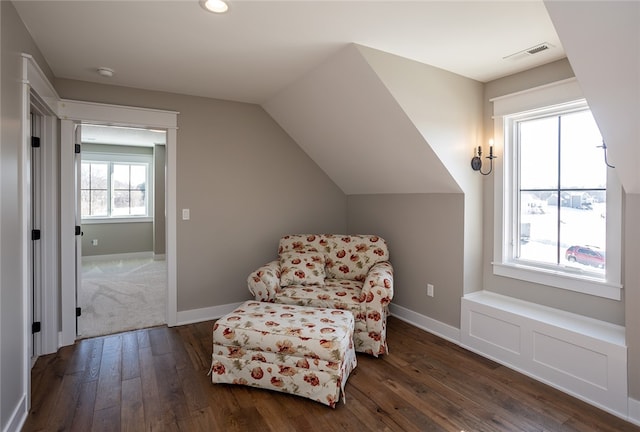 living area with dark hardwood / wood-style floors and vaulted ceiling