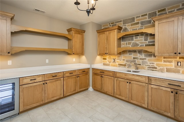 kitchen featuring a chandelier, light tile floors, wine cooler, tasteful backsplash, and sink