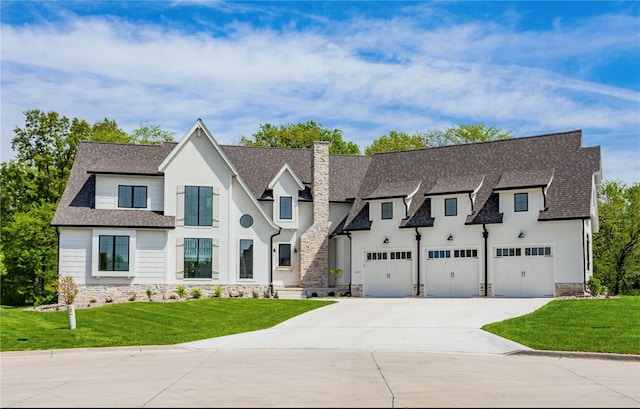 view of front of property featuring a front yard and a garage