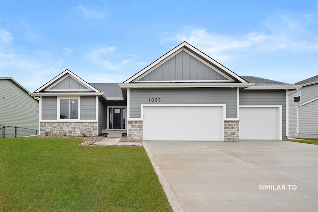 craftsman house with a front lawn and a garage