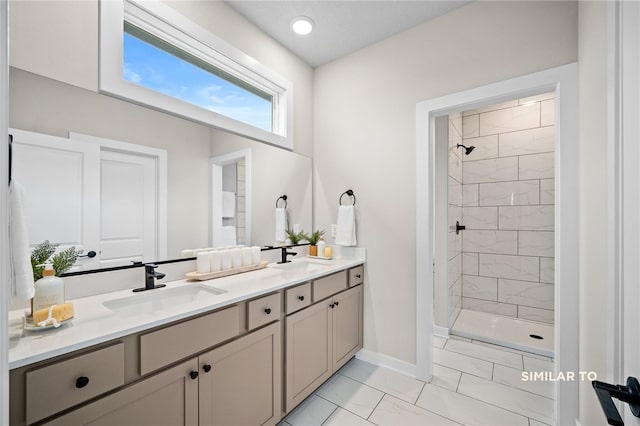 bathroom featuring dual vanity, tile flooring, and tiled shower