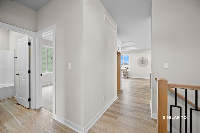 hallway with light hardwood / wood-style flooring