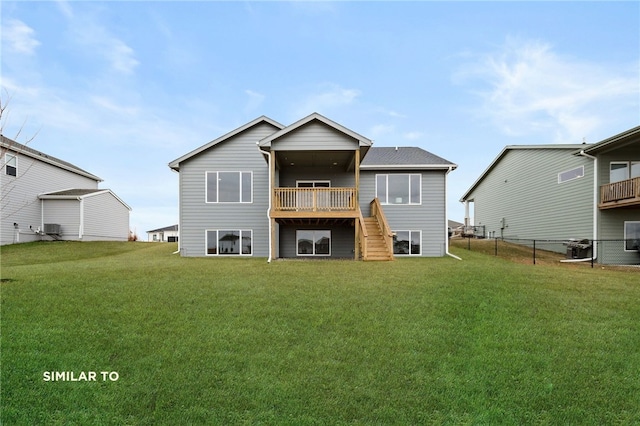 rear view of property with a balcony and a lawn