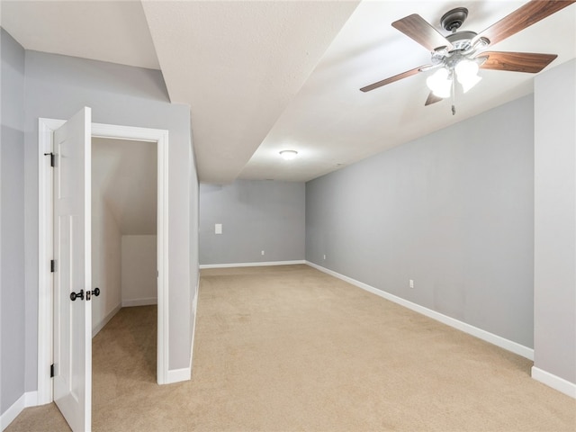 unfurnished room featuring ceiling fan and light colored carpet