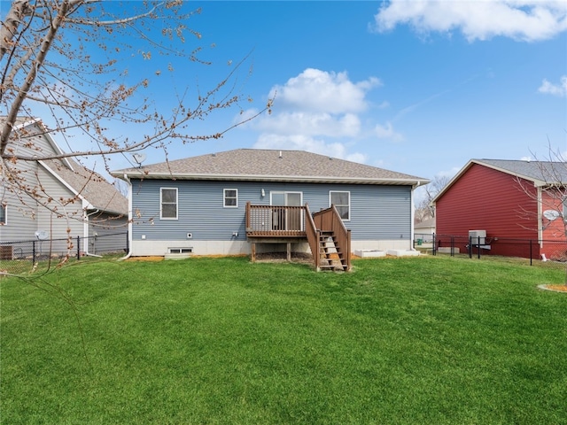 rear view of house with a deck and a yard