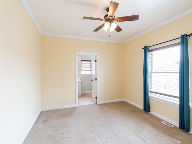 unfurnished room featuring carpet, ceiling fan, and crown molding