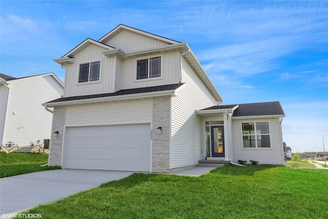 view of front of house with a front lawn, driveway, stone siding, board and batten siding, and a garage