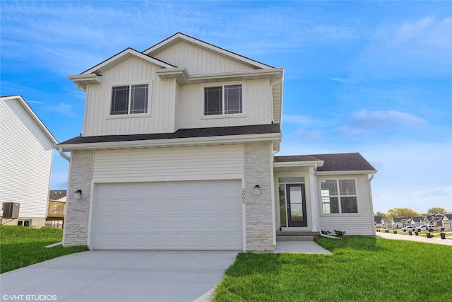 view of front of house featuring central air condition unit, a front yard, and a garage