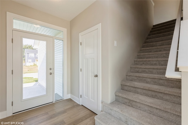 foyer entrance featuring a wealth of natural light and light hardwood / wood-style flooring