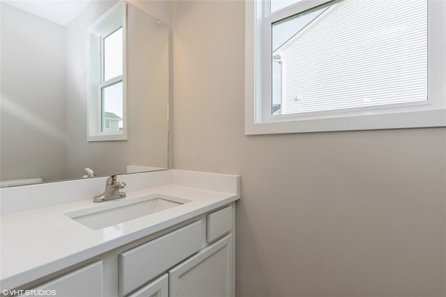 bathroom featuring toilet and vanity