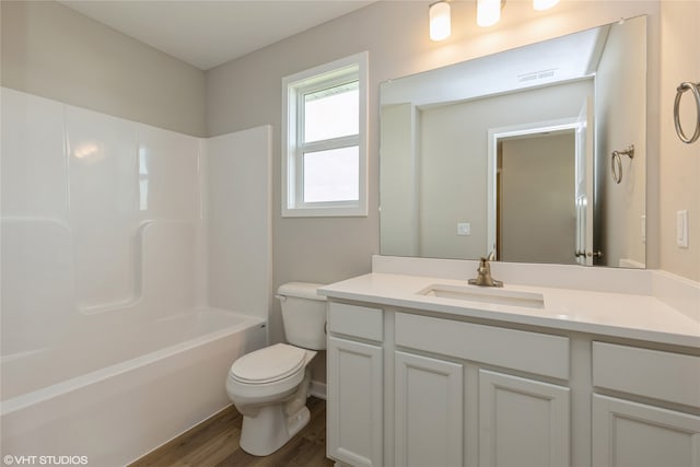 full bathroom with vanity, toilet, wood-type flooring, and shower / bathtub combination