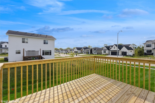 wooden deck featuring a yard