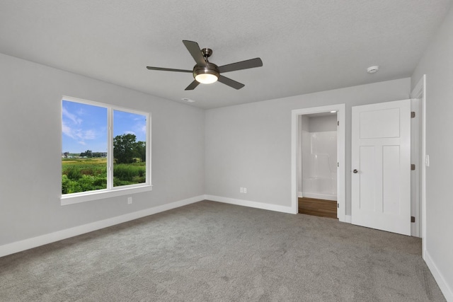 carpeted empty room featuring a textured ceiling and ceiling fan