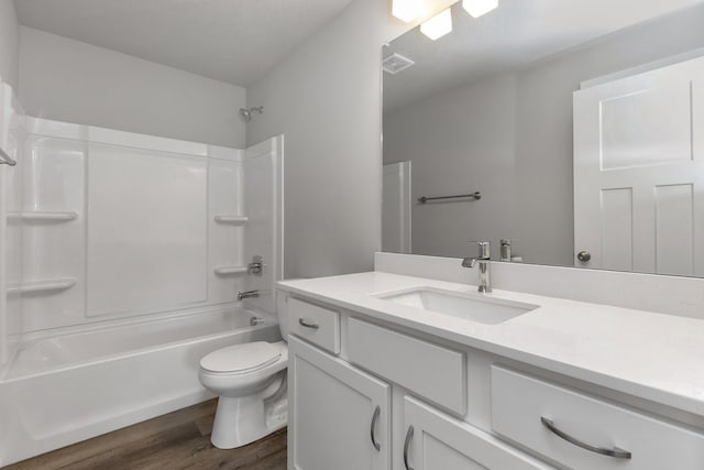 full bathroom with vanity, a textured ceiling, shower / bathing tub combination, wood-type flooring, and toilet