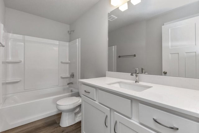 full bathroom with washtub / shower combination, wood-type flooring, toilet, and vanity