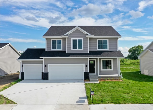 view of front of property featuring a garage and a front lawn