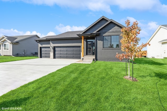 view of front of property with a garage and a front yard