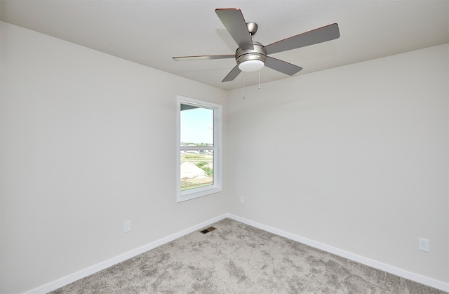 empty room featuring carpet flooring and ceiling fan