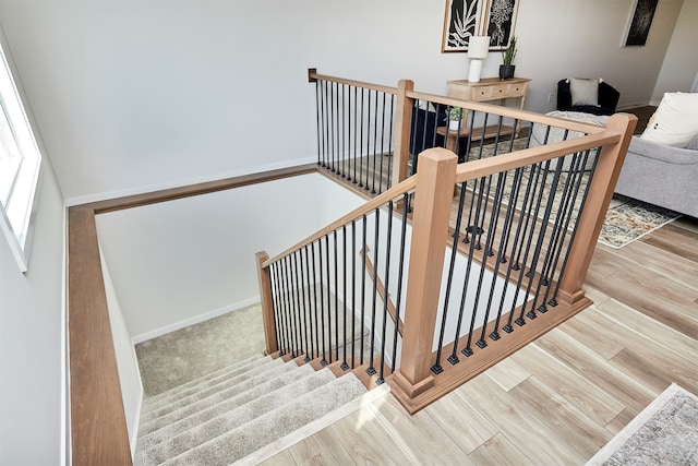 staircase featuring wood-type flooring