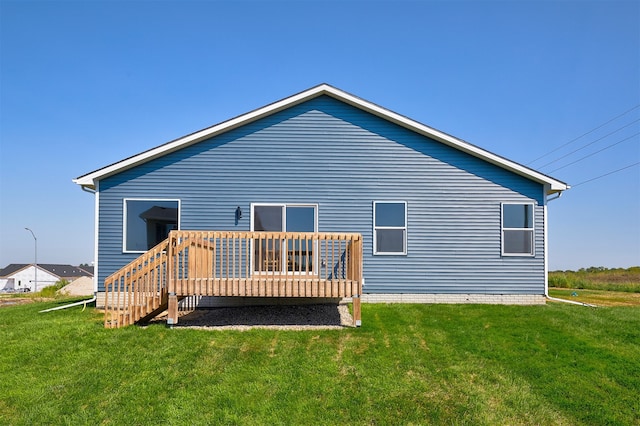 rear view of house with a lawn and a deck