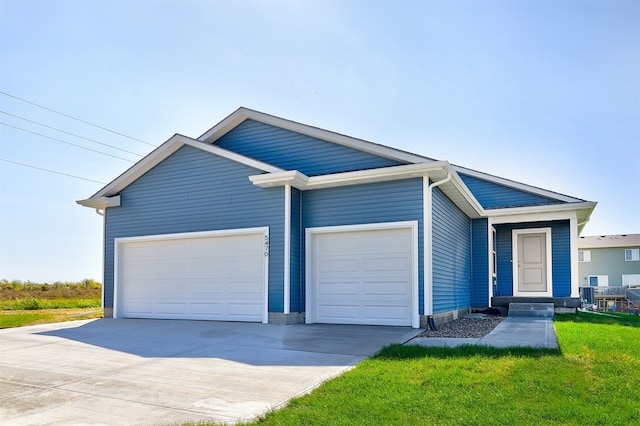 view of front of property featuring a garage and a front lawn