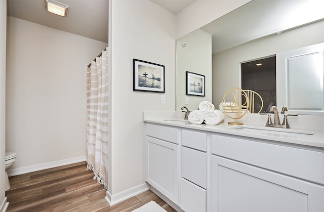 bathroom with a shower with shower curtain, vanity, toilet, and wood-type flooring