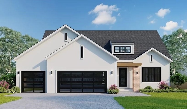 view of front of property featuring a garage and a front lawn