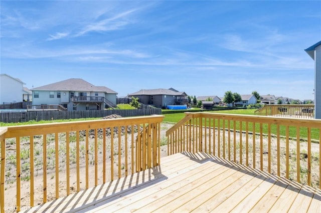 wooden terrace with a lawn