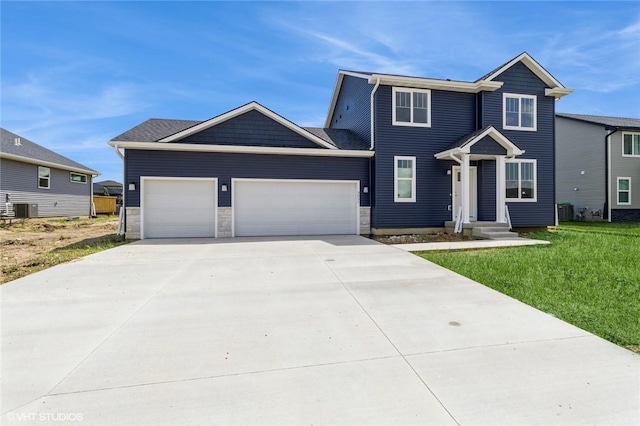 view of front of house featuring a front yard, central AC unit, and a garage