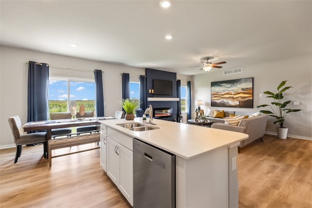 kitchen featuring white cabinets, dishwasher, sink, an island with sink, and ceiling fan