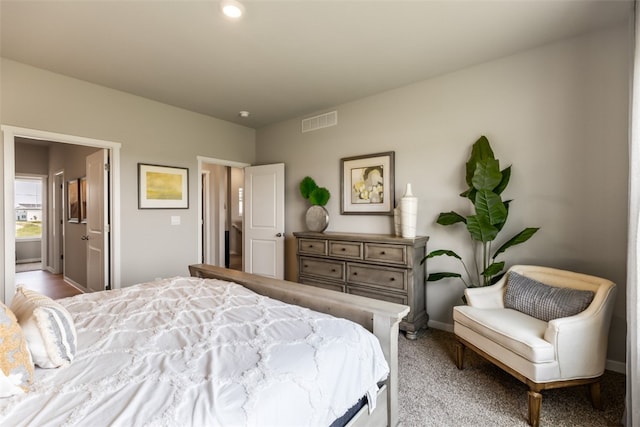 carpeted bedroom with visible vents and baseboards