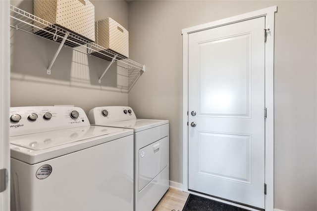 laundry area featuring laundry area, independent washer and dryer, and light wood-style flooring