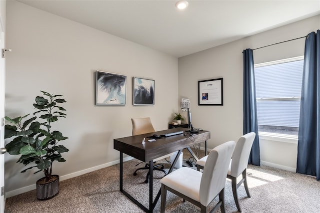 home office featuring a healthy amount of sunlight, baseboards, and light carpet