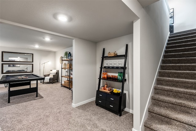 rec room with a textured ceiling and carpet floors