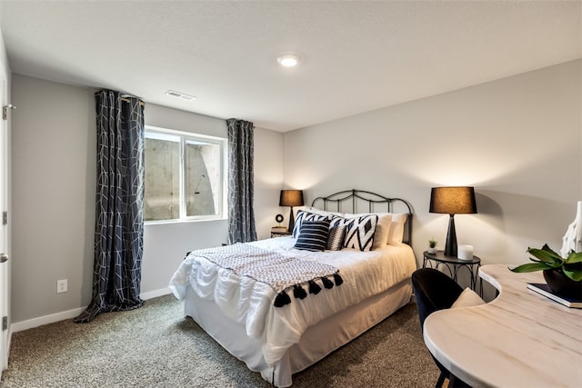 carpeted bedroom with baseboards and visible vents