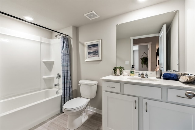 bathroom featuring visible vents, toilet, shower / bath combination with curtain, baseboards, and vanity