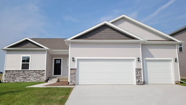 craftsman house with a garage and a front yard