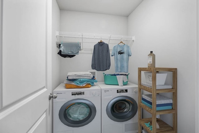 clothes washing area featuring washer and clothes dryer