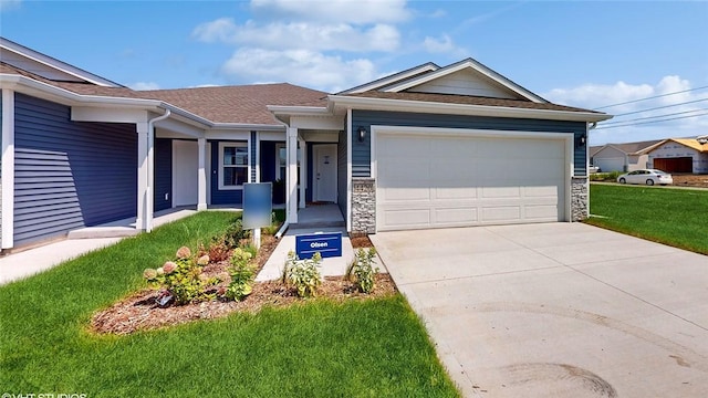 ranch-style house featuring a garage and a front lawn