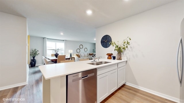 4416 NE 13th St, Ankeny, IA 50021 - kitchen with light wood finished floors, stainless steel appliances, a peninsula, and a sink