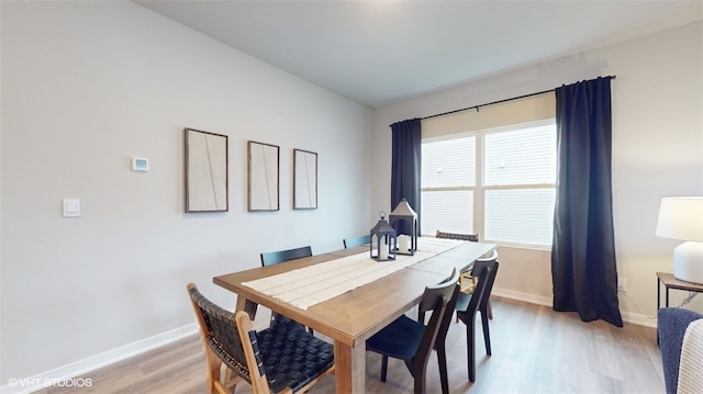 dining space with light hardwood / wood-style floors