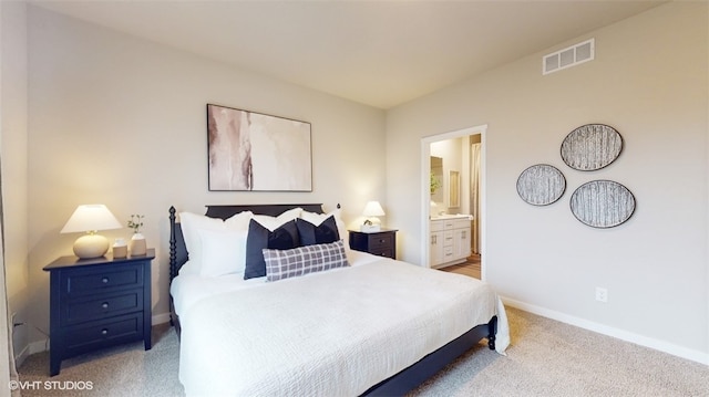 carpeted bedroom featuring ensuite bathroom