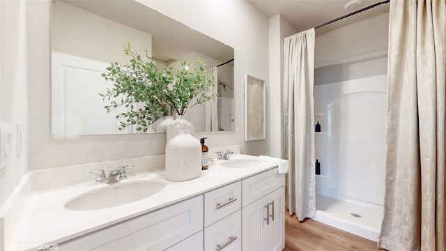 bathroom featuring hardwood / wood-style flooring, vanity, and a shower with curtain